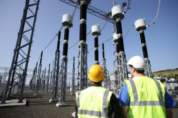 Two engineers discussing energy grid requirements